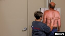 FILE PHOTO: Former coal miner Wade Pauley, who has Black Lung disease after working 33 years underground in mines, stands for a chest x-ray at United Medical Services in Pikeville, Kentucky, U.S., May 22, 2018.