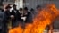 Ultra-Orthodox Jewish men pray as they burn leaven in the Mea Shearim neighbourhood of Jerusalem, ahead of the Jewish holiday of Passover, April 14, 2014.