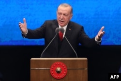 FILE - Turkish President Recep Tayyip Erdogan delivers a speech at the Bestepe National Congress and Culture Center in Ankara, July 21, 2020.