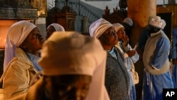 Nigerian worshippers pray in the Church of the Nativity, traditionally believed to be the birthplace of Jesus, on Christmas Eve, in the West Bank city of Bethlehem, Dec. 24, 2024.