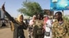 Sudanese demonstrators take a selfie during a rally outside the army headquarters in the Sudanese capital Khartoum on April 13, 2019. 