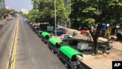 Police vehicles line a street at Kyauktada police station in Yangon, Feb. 1, 2021, hours after Myanmar's military announced it was taking control of the country for one year.