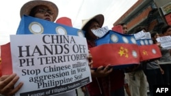 Filipino students hold replicas of Chinese maritime surveillance ships as they shout anti-Chinese slogans during a rally near Malacanang Palace in Manila on March 3, 2016, to denounce reported Chinese vessels dropping anchor near a South China Sea atoll a