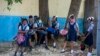 Student wait their turn to enter Lycee Marie Jeanne school on first day of school since the COVID-19 pandemic in Port-au-Prince, Haiti, Monday, Aug. 17, 2020. (AP Photo/Dieu Nalio Chery)