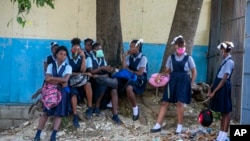 Student wait their turn to enter Lycee Marie Jeanne school on first day of school since the COVID-19 pandemic in Port-au-Prince, Haiti, Monday, Aug. 17, 2020. (AP Photo/Dieu Nalio Chery)