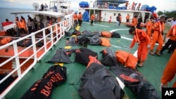 Body bags containing the bodies of the victims of a ferry that sank off Sulawesi Island last Saturday are laid on the deck of a rescue ship in the Gulf of Bone, Indonesia, Dec. 24, 2015. 