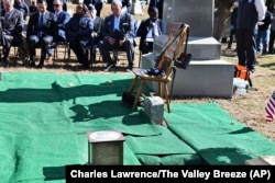 An urn containing the cremated remains of Byron R. Johnson, a Union soldier who was born in Pawtucket, R.I., in 1844 and fought in the Civil War, rests at his burial site during funeral services at Oak Grove Cemetery in Pawtucket, Oct. 16, 2024.