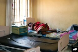 FILE - A pregnant woman lies on a bed in the maternity ward of the Juba Teaching Hospital, in the capital Juba, South Sudan, March 11, 2019.