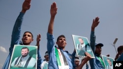 FILE - Graduate students take part in a parade in support of the Houthi movement in Sanaa, Yemen, June 9, 2024. The posters show Abdul-Malek al-Houthi, the leader of the Houthi movement.