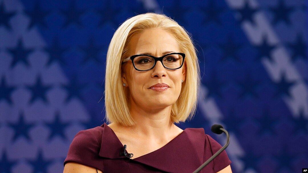 FILE - U.S. Rep. Kyrsten Sinema, D-Ariz., goes over the rules in a television studio prior to a televised debate with U.S. Rep. Martha McSally, R-Ariz., in Phoenix, Oct. 15, 2018.