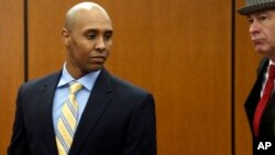 FILE - Mohamed Noor, left, waits with his attorney, Tom Plunkett, as they arrive at the Hennepin County Government Center for a hearing in Minneapolis, May 8, 2018. 