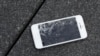 FILE - An Apple iPhone with a cracked screen after a drop test is seen at the offices of SquareTrade in San Francisco.