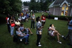 Voters line up at Christian City, an assisted living home, to cast their ballots after Democratic and Republican primaries were delayed due to coronavirus disease (COVID-19) restrictions