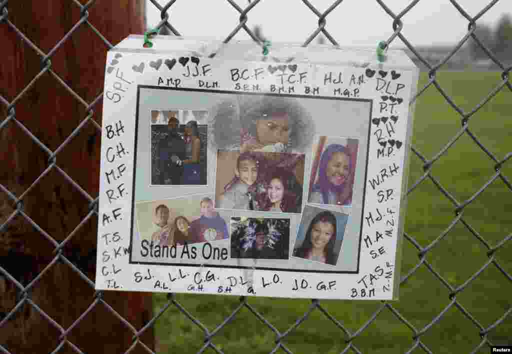 A memorial consisting of photos of the victims is seen outside of Marysville-Pilchuck High School the day after a school shooting in Marysville, Washington, Oct. 25, 2014. 