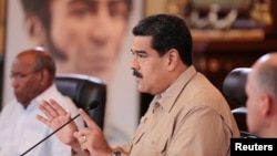 FILE - Venezuela's President Nicolas Maduro speaks during a meeting with ministers at Miraflores Palace in Caracas, Venezuela, Dec. 1, 2016.