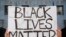 A supporter of Black Lives Matter holds a sign during a protest outside the Hall of Justice as they demonstrate against the death of George Floyd, in Los Angeles, California, on June 10, 2020. 