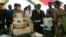 Zimbabwe President Robert Mugabe (4th R) and first lady Grace Mugabe (2nd R) stand with the president's birthday cake among guests on the occasion of his 89th birthday celebrations held in his honour at the State House, the eve of his birthday, February 20