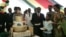 FILE: Zimbabwe President Robert Mugabe (4th R) and first lady Grace Mugabe (2nd R) stand with the presidents birthday cake among guests on the occasion of his 89th birthday celebrations held in his honour at the State House, the eve of his birthday, February 20