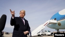 U.S. President Donald Trump talks to reporters prior to boarding Air Force One as he departs Washington for campaign travel to California from Joint Base Andrews in Maryland, Feb. 18, 2020.