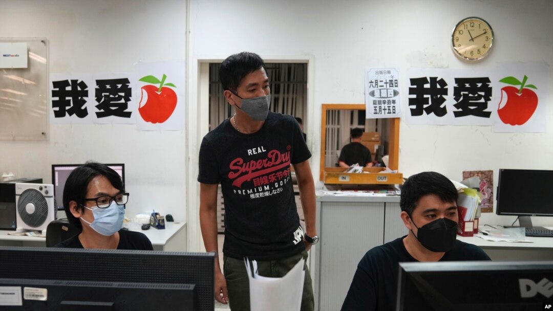 Staff members design their layout for the last edition of newspaper in the Apple Daily headquarters in Hong Kong, June 23, 2021.