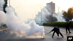 Police officers fire tear gas to disperse the supporters of imprisoned former Prime Minister Imran Khan's party Pakistan Tehreek-e-Insaf during a protest in Islamabad, Pakistan, Oct. 4, 2024.