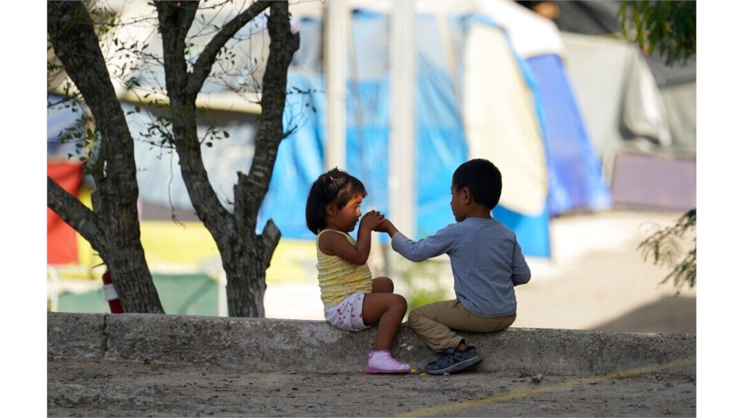 FILE - Children play at a camp of asylum-seekers in Matamoros, Mexico, Nov. 18, 2020. Some asylum-seekers were told March 5, 2021, that the U.S. may reopen their cases and allow them to enter the U.S. to wait out the asylum process.