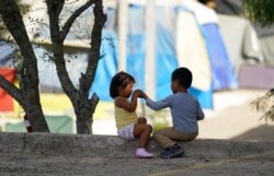 FILE - Children play at a camp of asylum-seekers in Matamoros, Mexico, Nov. 18, 2020. Some asylum-seekers were told March 5, 2021, that the U.S. may reopen their cases and allow them to enter the U.S. to wait out the asylum process.