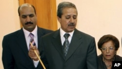 FILE - In this July 3, 2008 photo, Nawaf Fares, center, governor of the Quneitra, Syria, briefs a U.N. delegation visiting the city of Quneitra in the Golan Heights to investigate Israeli practices in occupied Arab lands.