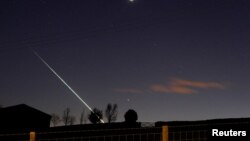 FILE - in an earlier meteorite strike, one creates a streak of light across the night sky over the North Yorkshire moors at Lealholm, near Whitby, northern England, April 26, 2015. 