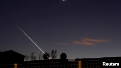 FILE - in an earlier meteorite strike, one creates a streak of light across the night sky over the North Yorkshire moors at Lealholm, near Whitby, northern England, April 26, 2015. 