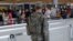 A U.S. Army Specialist monitors the security line at John F. Kennedy international Airport in the Queens borough of New York, June 29, 2016.
