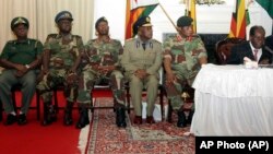 Zimbabwean President Robert Mugabe delivers his speech during a live broadcast at State House in Harare, Sunday, Nov, 19, 2017. Zimbabwe's President Robert Mugabe has baffled the country by ending his address on national television without announcing his resignation. (AP Photo)