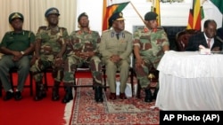 Members of the Zimbabwe Defence Forces, including police chief Augustine Chihuri, at State House after they staged a coup and put then President Robert Mugabe under house arrest. (AP Photo)