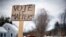 A handmade sign stuck in a snowbank on a rural road urges citizens to vote, Tuesday, Nov. 4, 2014, in Searsmont, Maine.