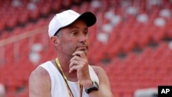 FILE - Track coach Alberto Salazar watches a training session at the Bird's Nest stadium in Beijing, Aug. 21, 2015.