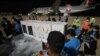 Workers move boxes loaded with COVID-19's vaccine before a handing over ceremony at Phnom Penh International Airport, in Phnom Penh, Cambodia, Tuesday, March 2, 2021. More than 300,000 doses of AstraZeneca COVID-19 vaccines from Serum Institute of…