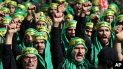 Lebanese Shi'ite supporters of the Iranian-backed Hezbollah group, shout slogans as they march marking the Ashoura holiday, in a southern suburb of Beirut, Lebanon, Oct. 12, 2016. Hezbollah – known as “the Party of God” – is considered a terrorist organization by the U.S. and European allies, and follows a Shi'ite ideology that calls for the destruction of Israel. 