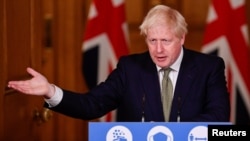 Britain's Prime Minister Boris Johnson gestures as he speaks during a virtual news conference on the ongoing situation with the coronavirus disease (COVID-19), at Downing Street, London, Oct. 12, 2020. 