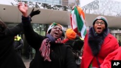 Supporters of former Ivory Coast president Laurent Gbagbo celebrate outside the International Criminal Court in The Hague, the Netherlands, Feb.1, 2019.