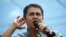 FILE - In this June 22, 2019, photo, Honduras' President Juan Orlando Hernández listens to the crowd as he delivers his speech during a rally in Tegucigalpa, Honduras. 