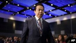 FILE - Interpol President Meng Hongwei walks toward the stage to address the Interpol World Congress in Singapore, July 4, 2017.