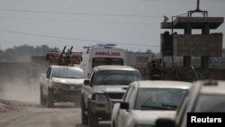 Turkey-backed Syrian rebel fighters return from the Syrian border town of Tal Abyad, on the Turkish-Syrian border in Akcakale, Turkey, Oct. 19, 2019.