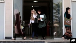 FILE - Afghan female students leave Kardan University in Kabul, Afghanistan, Sept. 15, 2013. “By targeting schools, terrorists take aim at a nation's best and brightest, and more broadly at its future,” one analyst says.