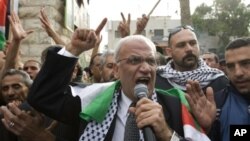 Palestinian chief peace negotiator Saeb Erakat takes part in a demonstration against the Al-Jazeera satellite channel in the West Bank city of Jericho, January 25, 2011