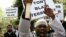 Michael Adebolajo, front, shouts slogans as Muslims march in London in a protest against the arrest of six people in anti-terror raids, April 2007.