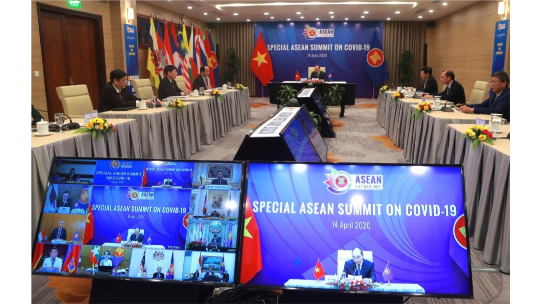 FILE - Vietnamese Prime Minister Nguyen Xuan Phuc, background, addresses ASEAN leaders during the Special ASEAN summit on COVID-19 in Hanoi, Vietnam, April 14, 2020.