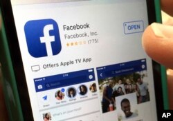 In this Monday, June 19, 2017, file photo, a user gets ready to launch Facebook on an iPhone, in North Andover, Mass. (AP Photo/Elise Amendola, File)