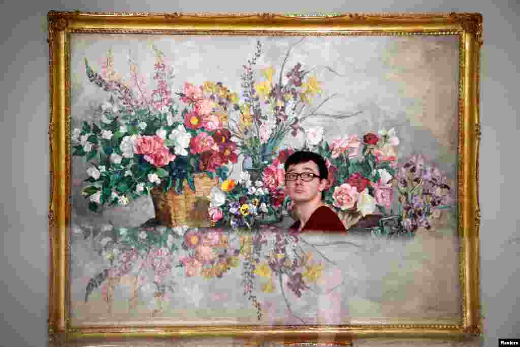 A visitor walks past the painting &quot;Various Flowers&quot; by Pyotr Konchalovsky at the Museum of Russian Impressionism in Moscow, Russia.