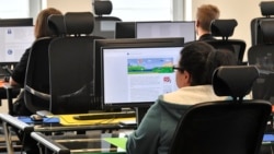 Employees of the Competence Call Center (CCC) work for the Facebook Community Operations Team in Essen, Germany, Thursday, Nov. 23, 2017. (AP Photo/Martin Meissner)