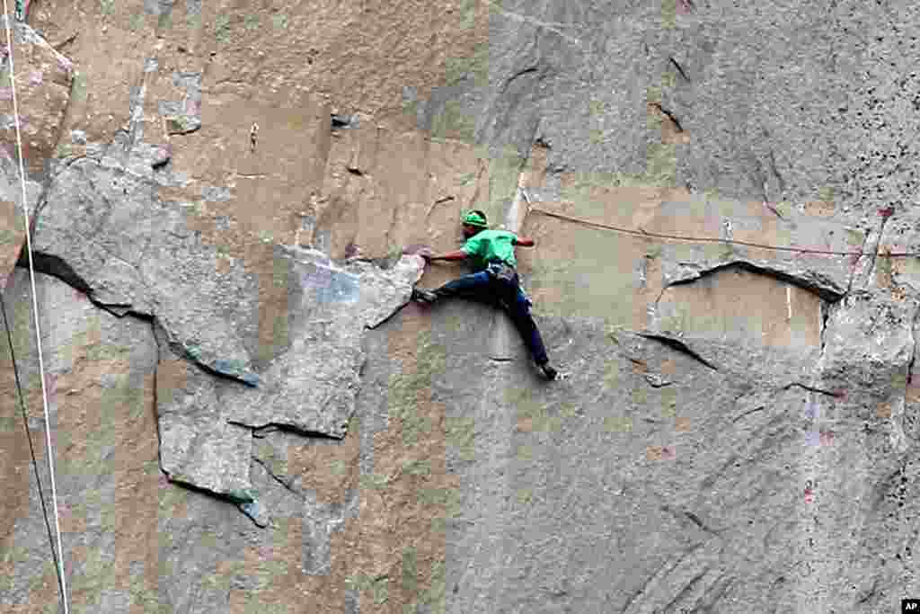 In this Jan. 9, 2015 photo provided by Tom Evans, Kevin Jorgeson climbs on what is known as Pitch 15. This&nbsp;free climb of El Capitan, the largest monolith of granite in the world, has been called the hardest rock climb in the world, Yosemite National Park, California.
